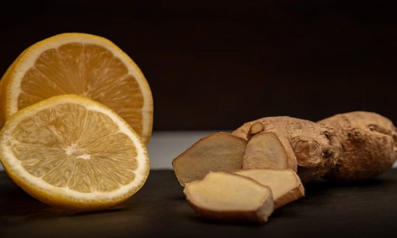 Close-up of fresh ginger root and lemon slices, highlighting their vibrant natural textures and health benefits.